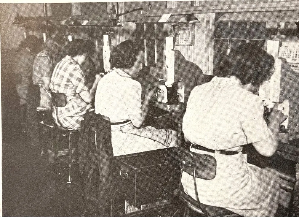 Women working at industrial machines in a Plainville factory